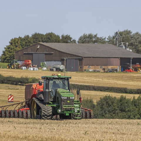 Green tractor, ploughing a field